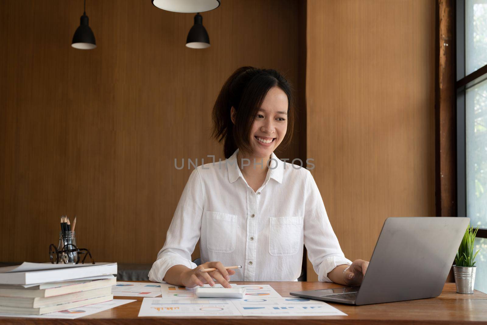 Accountant woman working with calculator and laptop computer, Tax deduction planning concept. Business woman calculating business balance prepare tax reduction