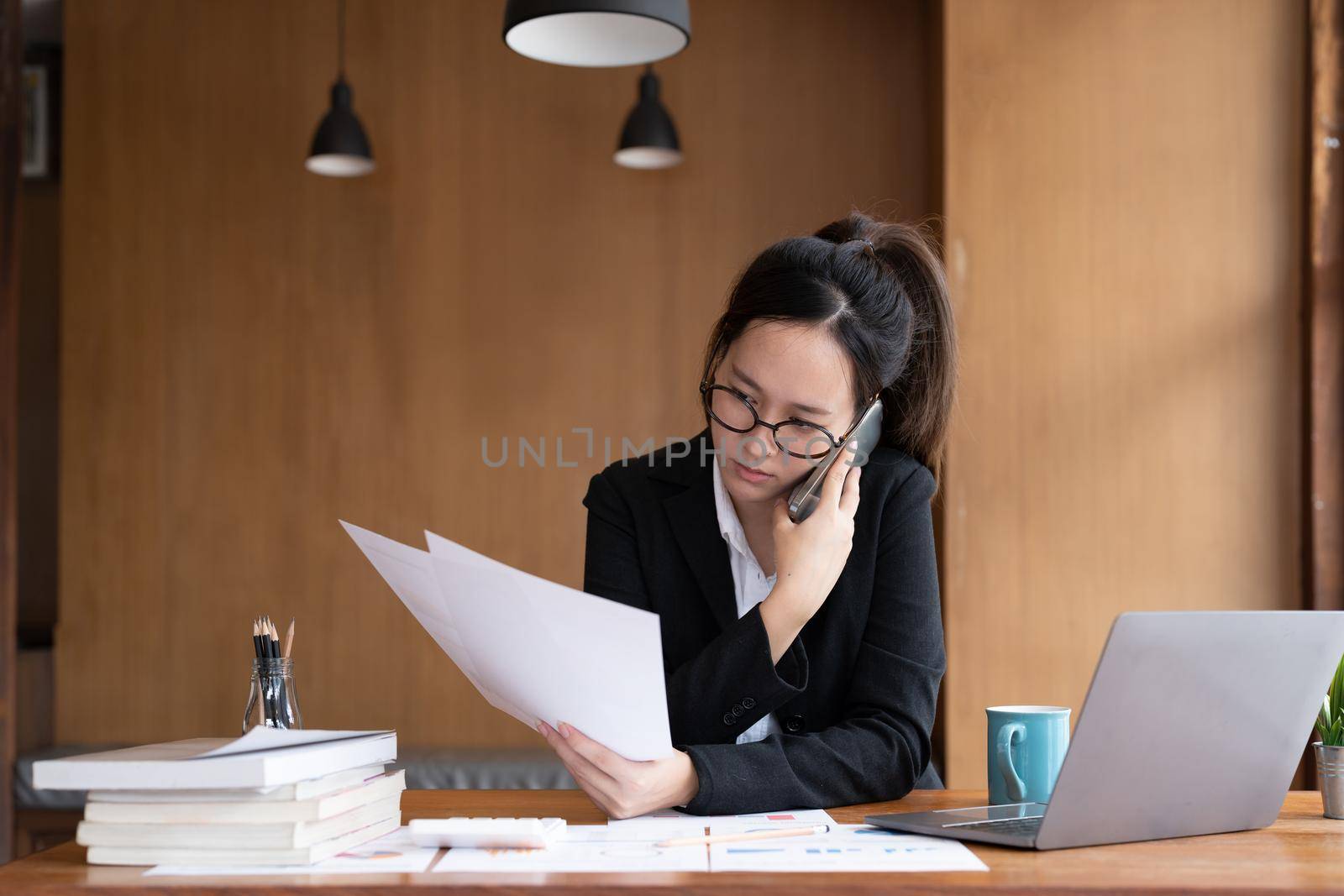 Busy business accountant woman making call phone in office and business working background, tax, accounting, statistics and analytic research concept.