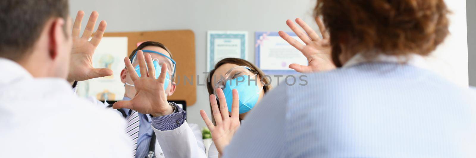Portrait of medical workers protect from patients wearing face mask and glasses. Man and woman doctors consult clients in office. Healthcare, help concept