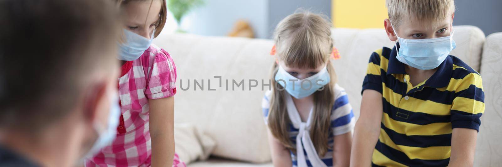 Portrait of children wearing face mask, virus spread in kindergarten, friends got sick. Kids playing card game with adults. Coronavirus, quarantine concept