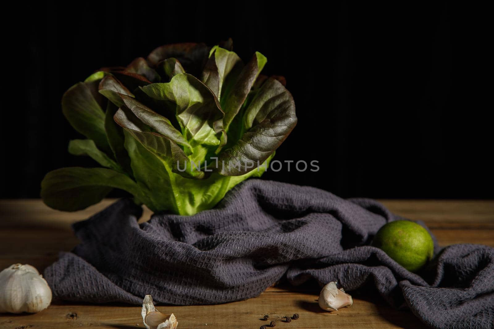 Bunch of fresh lettuce leaves on a dark background. Close-up.