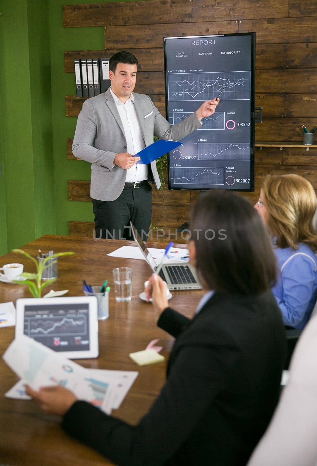 Young businessman presenting in front of leadership by DCStudio