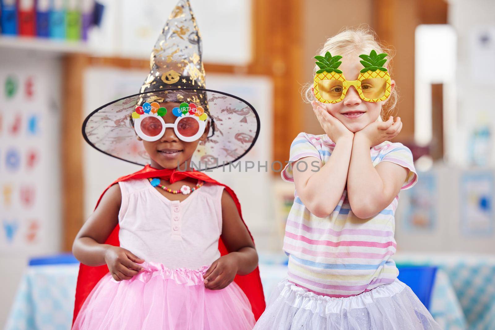Shot of two girls playing dress-up in class.