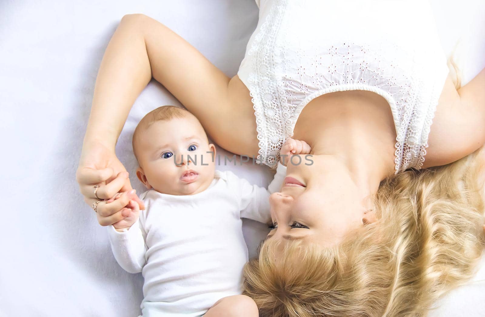 Mother with baby on a light background. Selective focus. People.