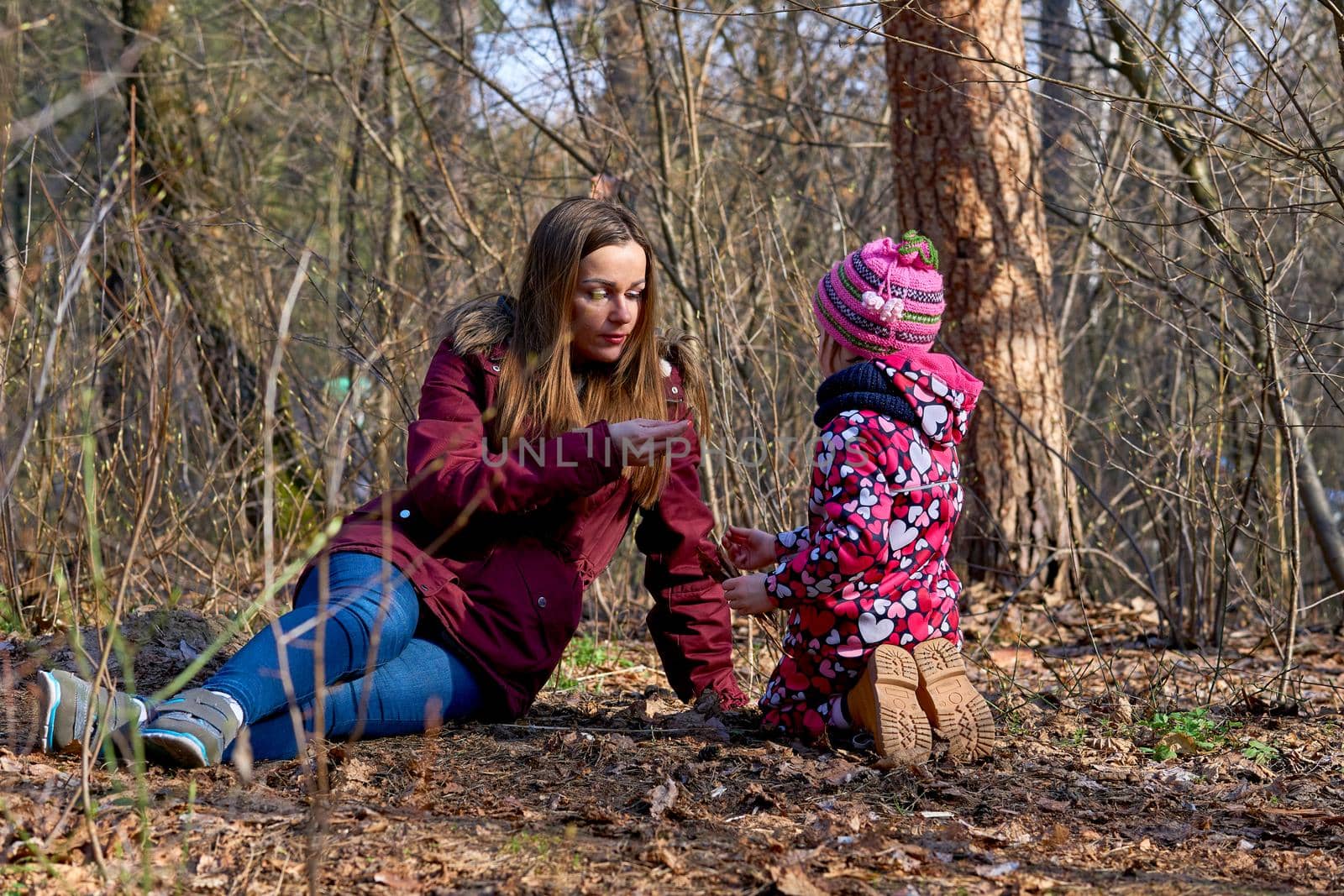 the process of receiving or giving systematic instruction, especially at a school or university. A young mother tells the child about the secrets and phenomena of nature in the spring autumn forest