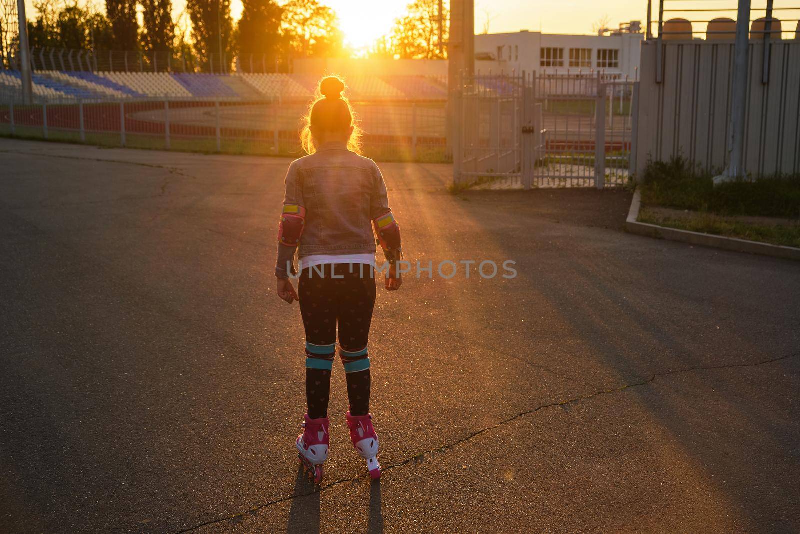 Girl riding roller skates in the park by InnaVlasova