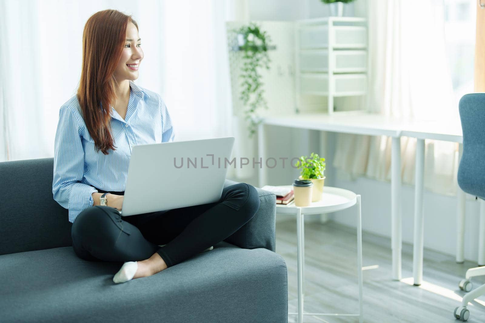 internet learning, online shopping, selling, meeting, information searching, Portrait of young Asian woman showing smiling face while using tablet to work at home. by Manastrong