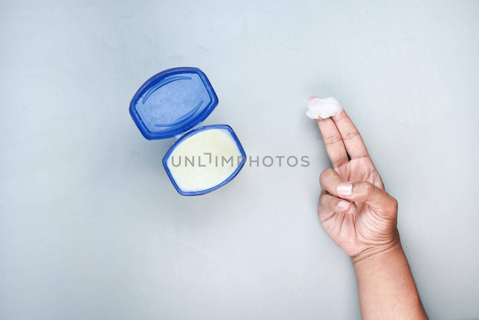 top view of man hand using petroleum jelly by towfiq007