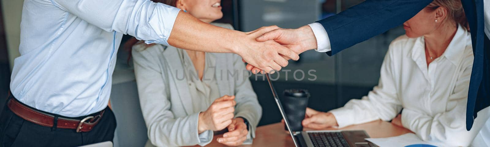 Business male partnership handshake. Photo handshaking process. Successful deal after meeting.