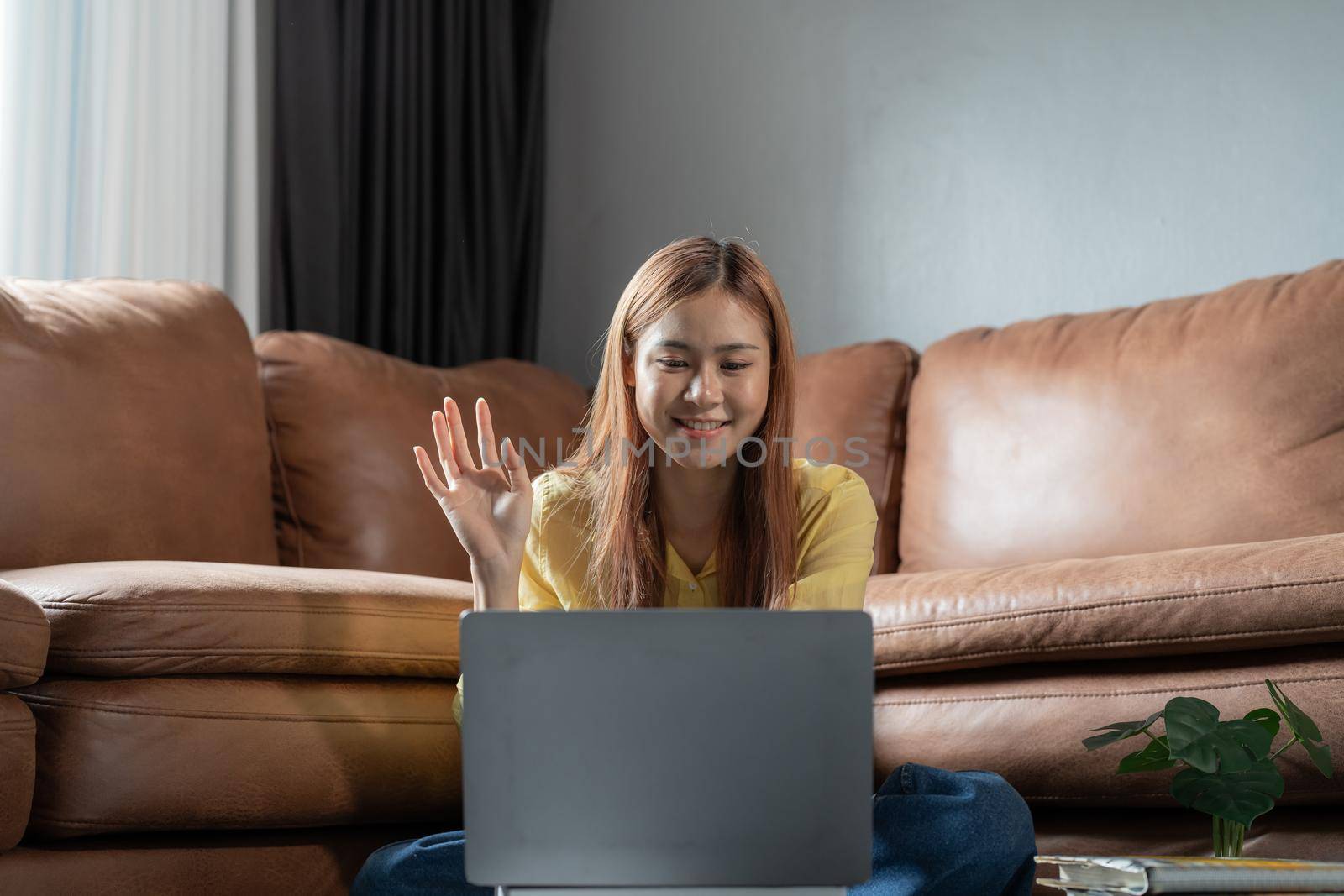 Attractive young asian girl student studying remotely via laptop computer at home, online education concept