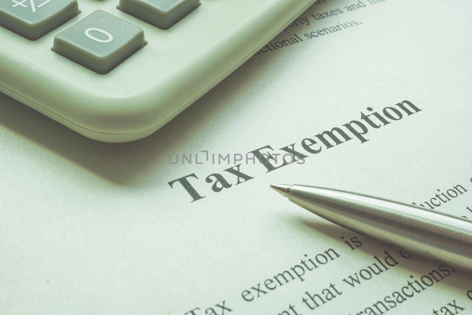 Info about tax exemption with calculator and a pen.