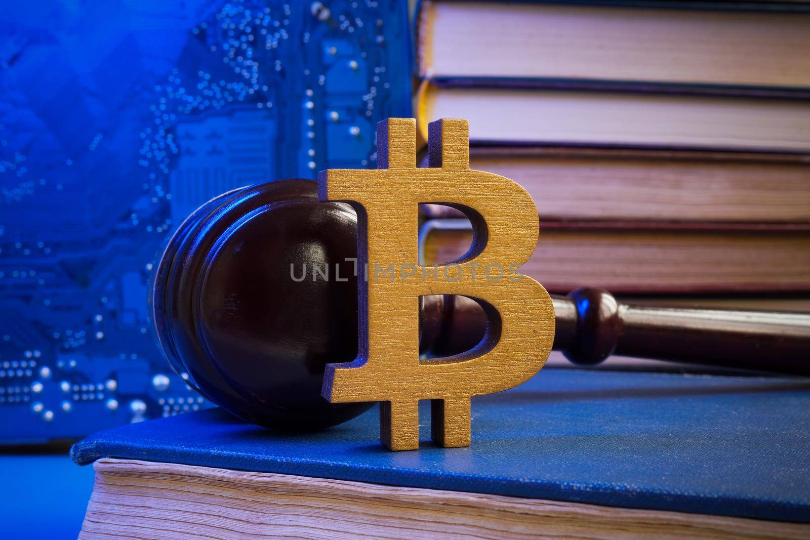 Bitcoin sign and gavel on a book. Cryptocurrency law concept.