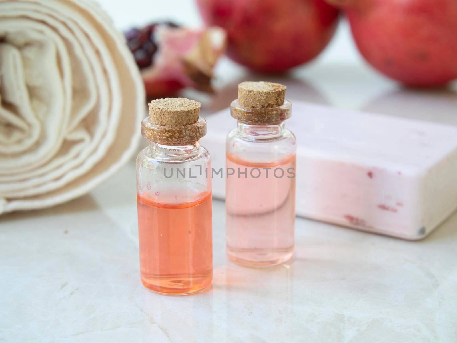 Two bottles of fruit extract and fruit soap.
