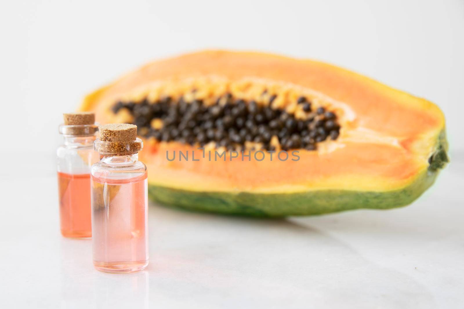 Small bottles of papaya extract with papaya fruit