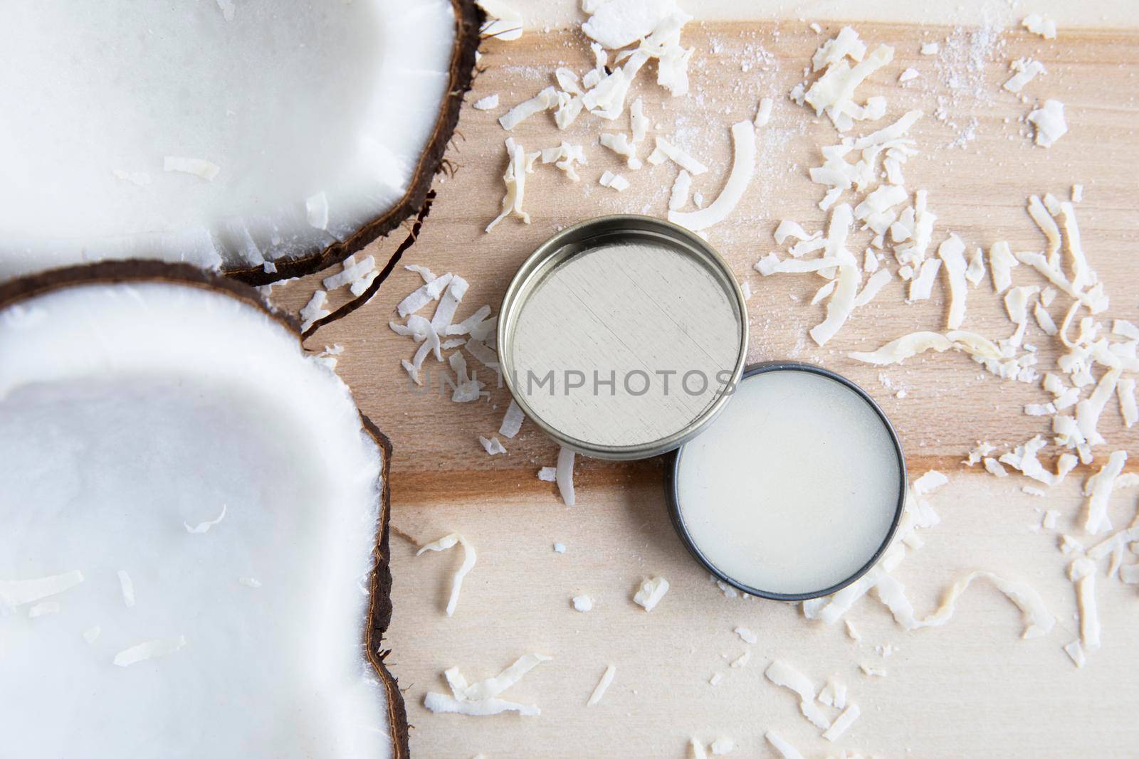 Coconuts with coconut cosmetic cream from a top down view.