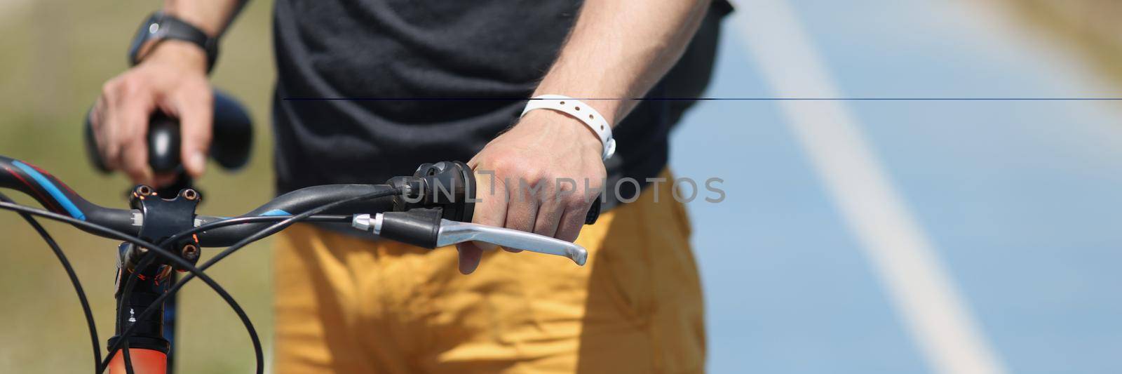 Close-up of man in sportswear standing near mountain bike. Male cyclist riding bicycle. Wheelman or bicycler. Cycling sport and healthy lifestyle concept