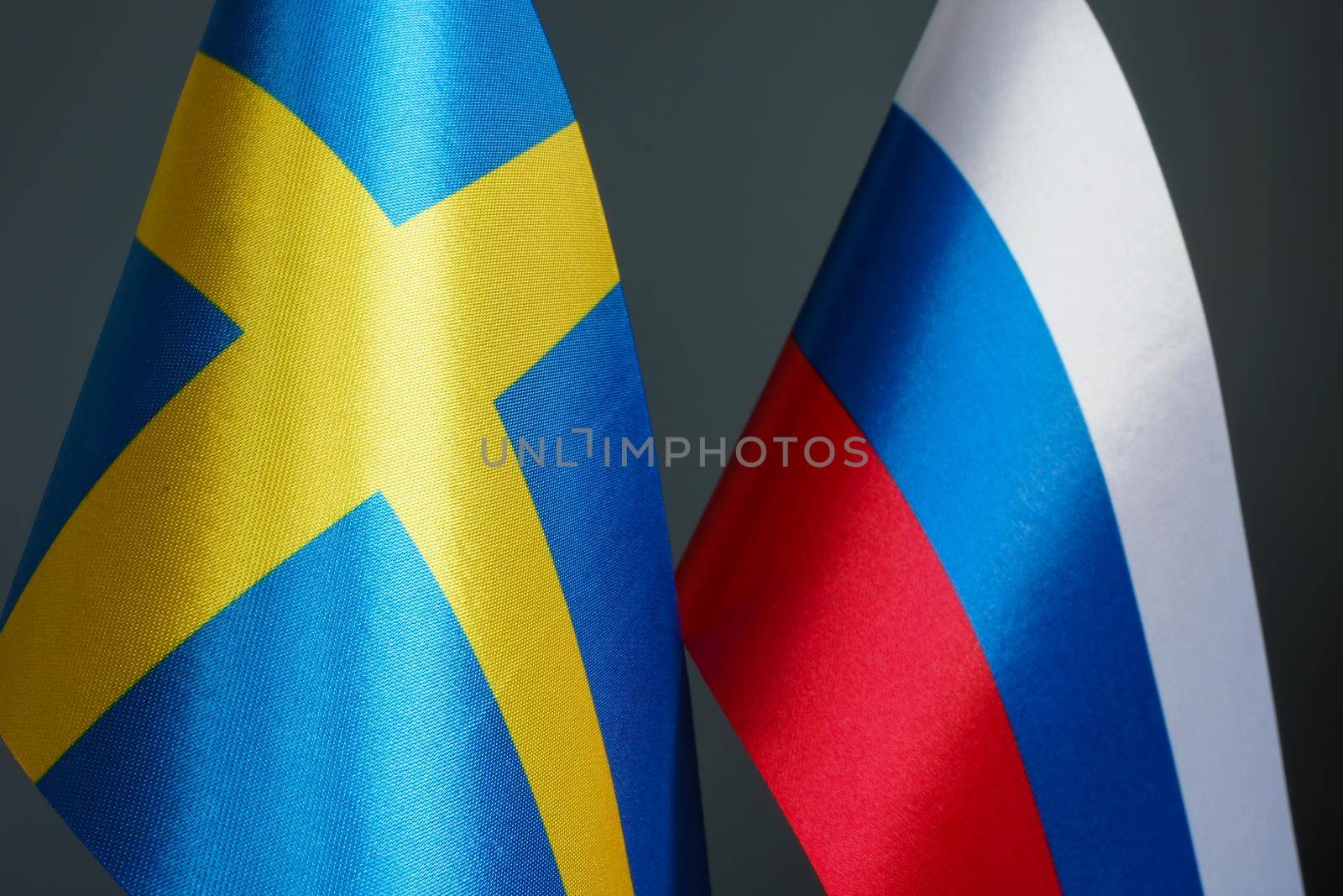 Closeup of the flags of Sweden and Russia.