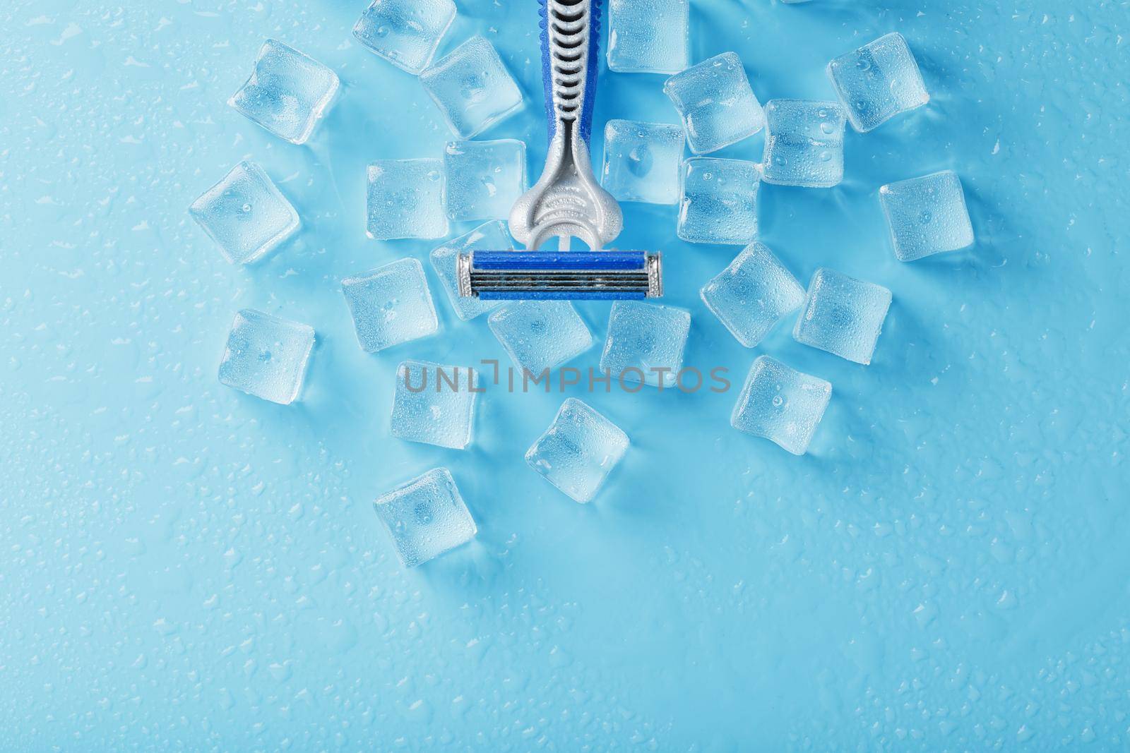 Refreshing shaving machines for the face against the background of frosty ice cubes by AlexGrec