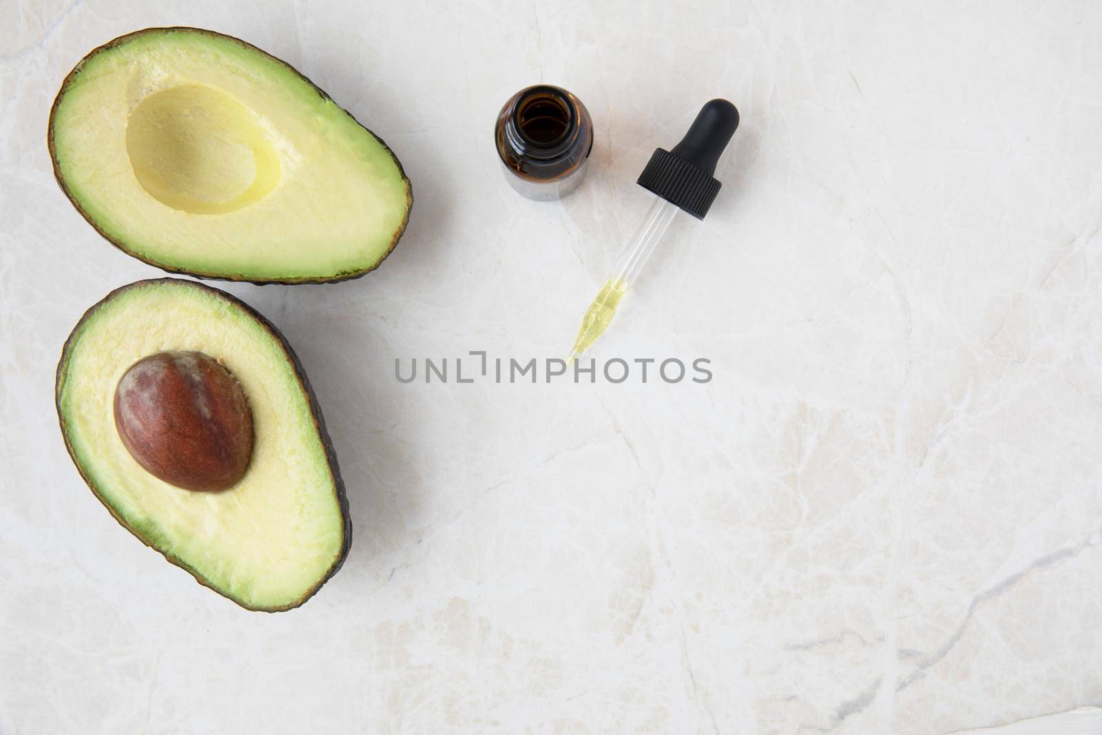 Avocados and Dropper of Oil by charlotteLake