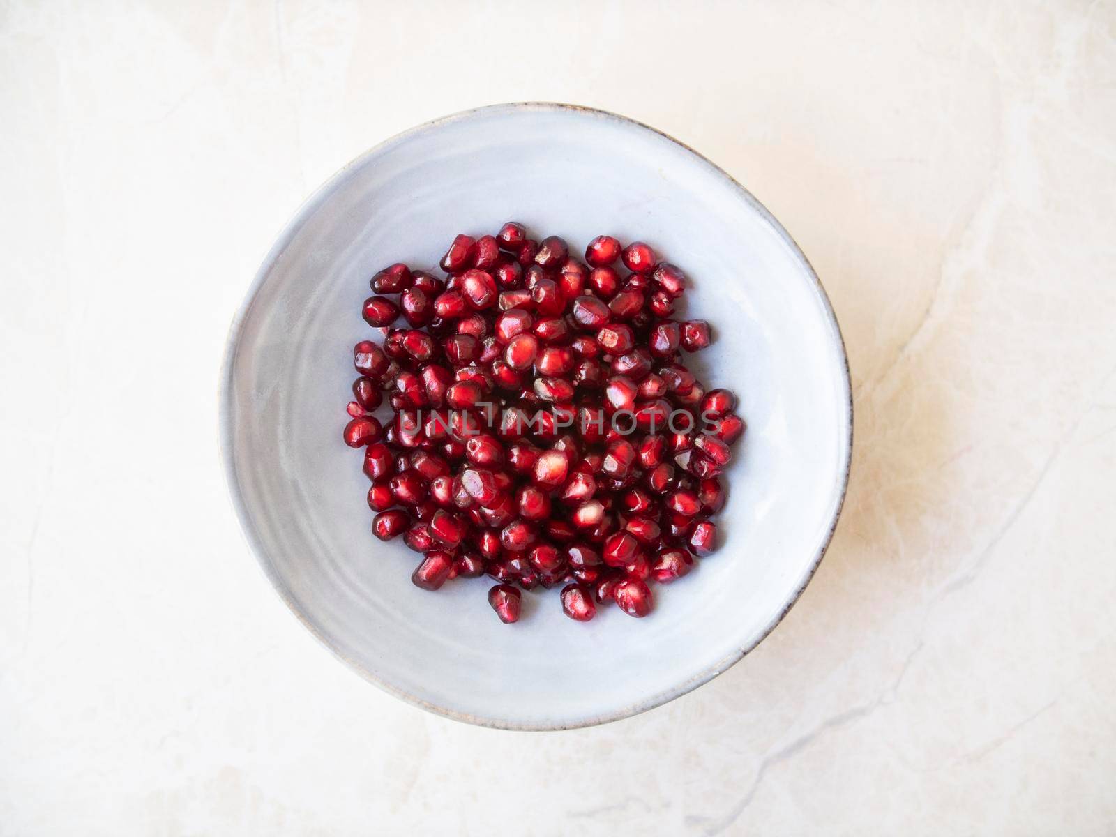 Pomegranate Seeds in Bowl by charlotteLake