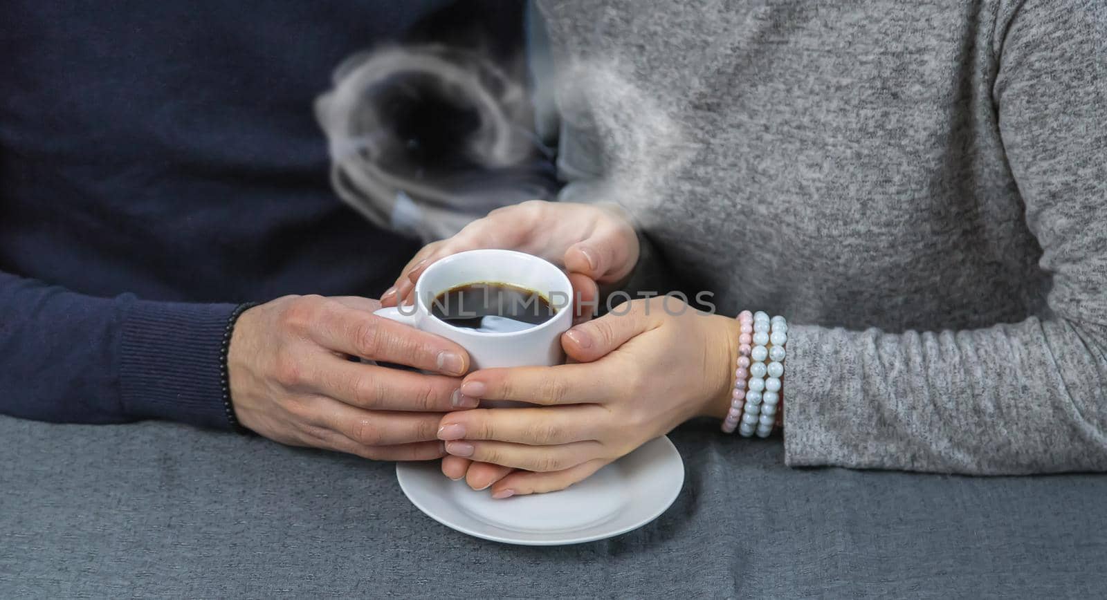 Man and woman at the table with a cup of coffee. Selective focus. People.