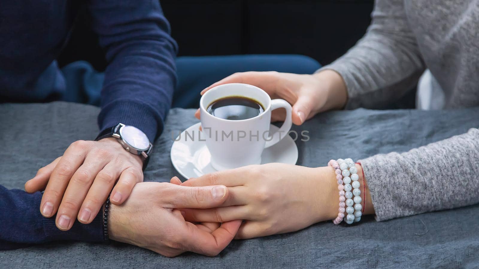 Man and woman at the table with a cup of coffee. Selective focus. People.