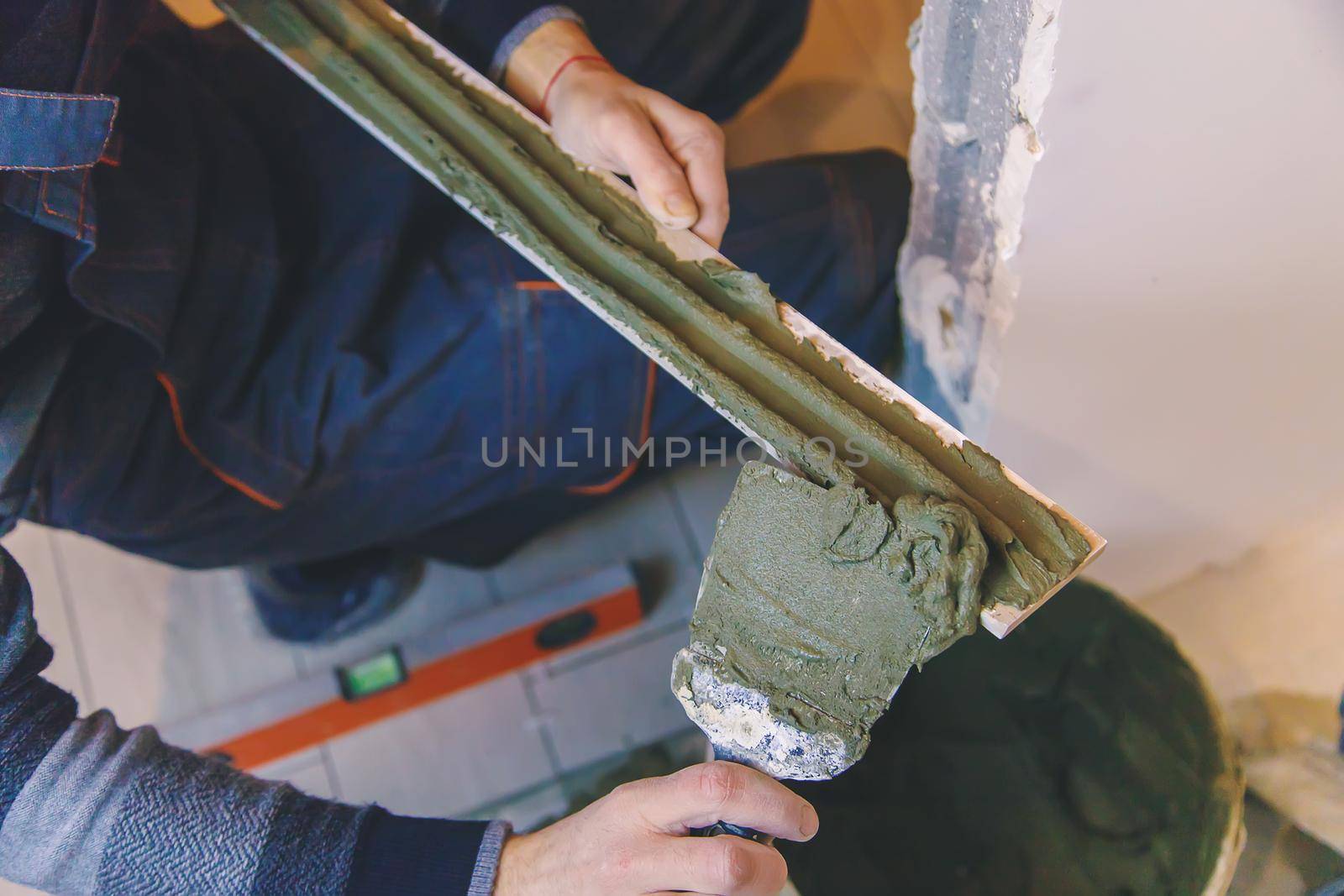 smear the tile repair in the house with a solution. Selective focus. white.