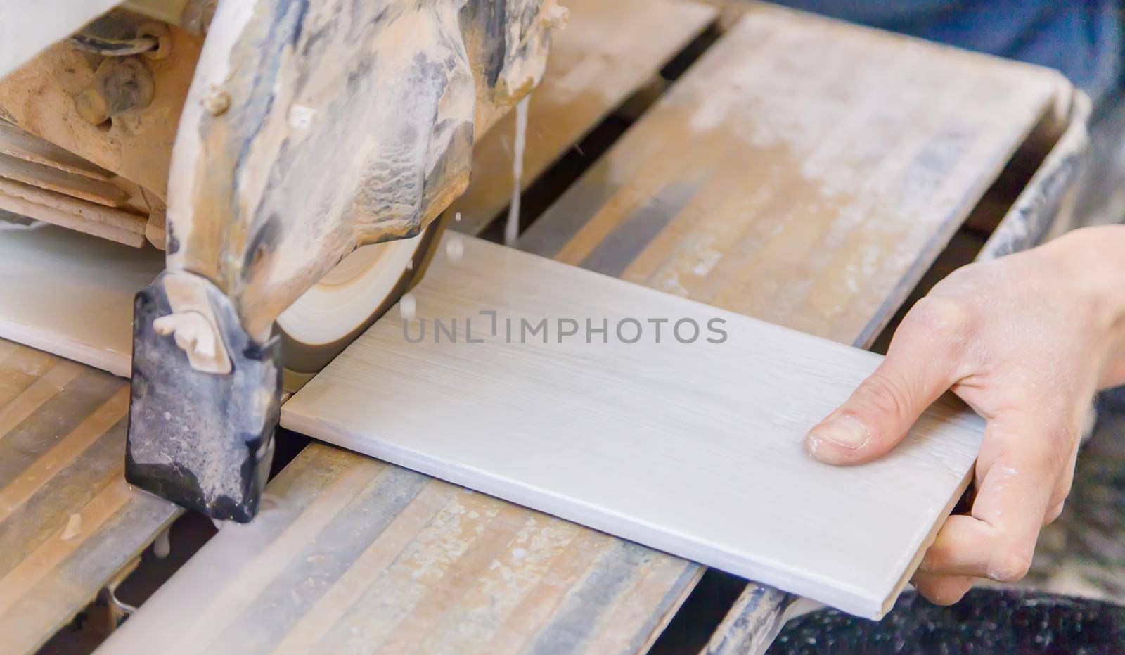 cut tiles with a tile cutter repair in the house. Selective focus. white.