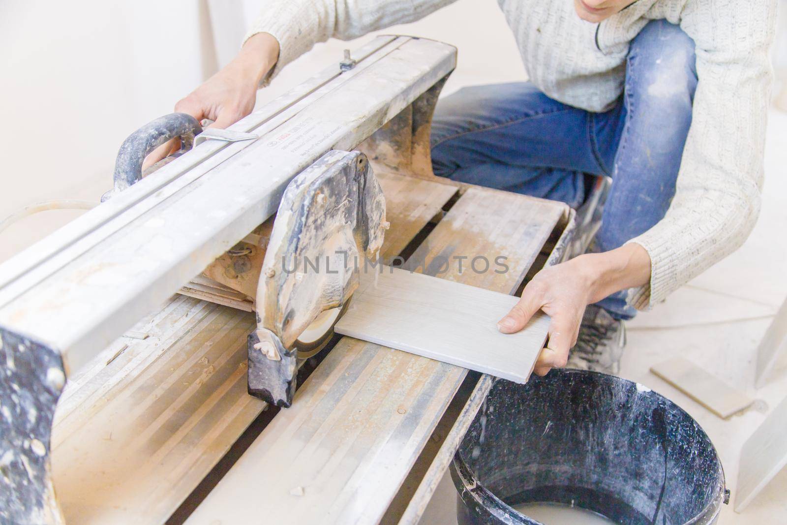 cut tiles with a tile cutter repair in the house. Selective focus. white.