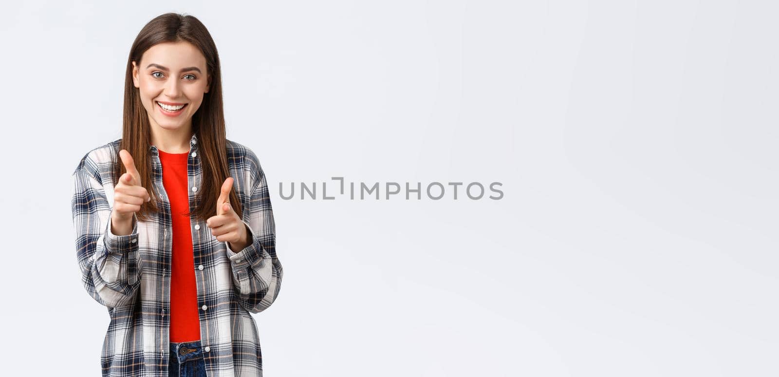 Lifestyle, different emotions, leisure activities concept. Enthusiastic and happy young pretty girl in casual outfit pointing fingers at camera, gotcha or congratulations gesture, choosing you.