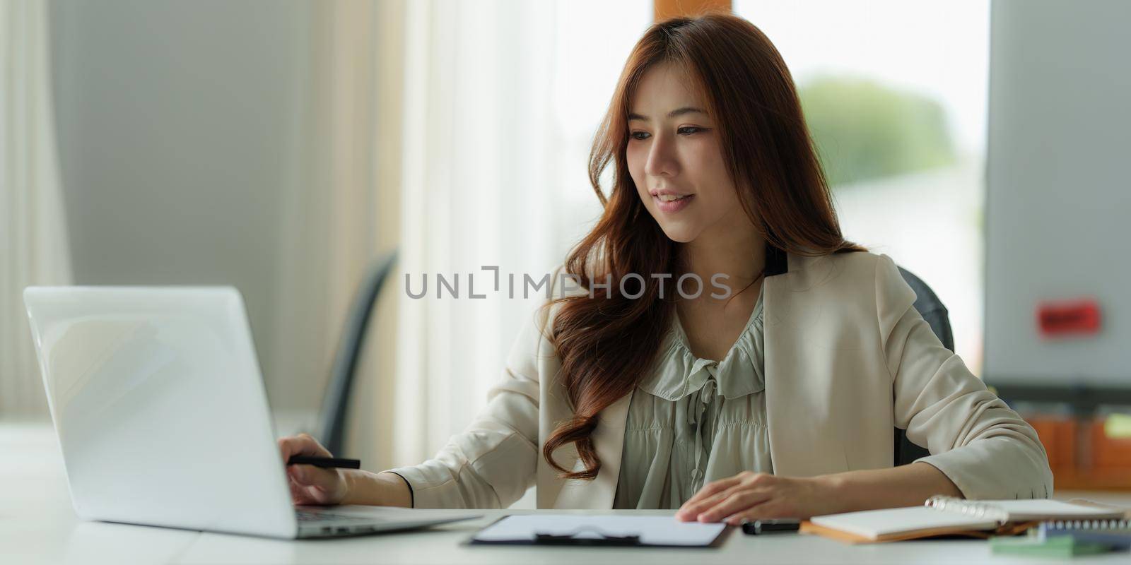 Image of Young business person working online on laptop computer. studying or working from home online concept. by itchaznong