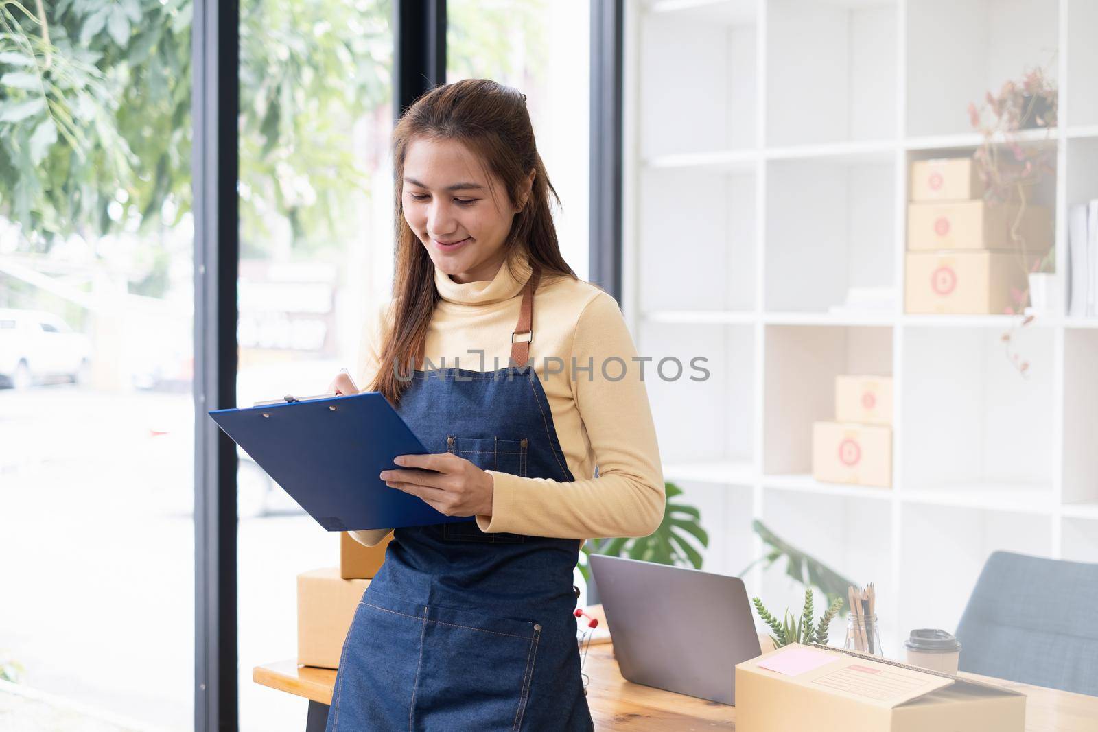 Asian small business owner working at home office. Business retail market and online sell marketing delivery, SME e-commerce concept. by itchaznong