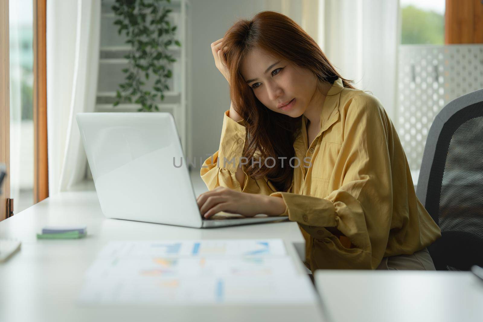 Image of Asian Business woman stressed after end of video conference at home. Expression and Emotional concept