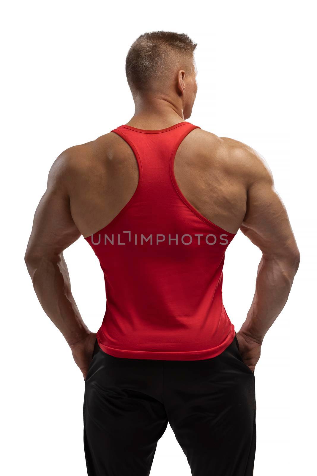 Portrait of an attractive athlete in a red tank top on a white cyclorama in the studio. Sports lifestyle.