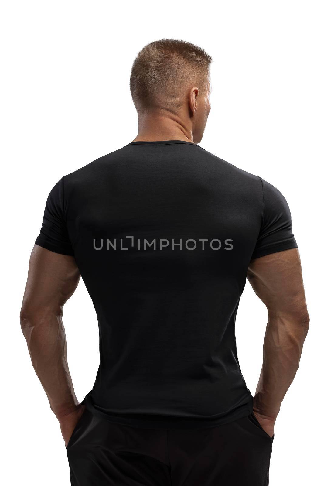 Handsome athletic man posing in T-shirt on a white background by but_photo