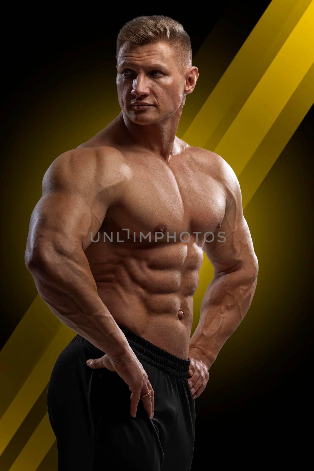 Professional bodybuilder in a dry filled form in a large weight category posing on a black background. Sports lifestyle.