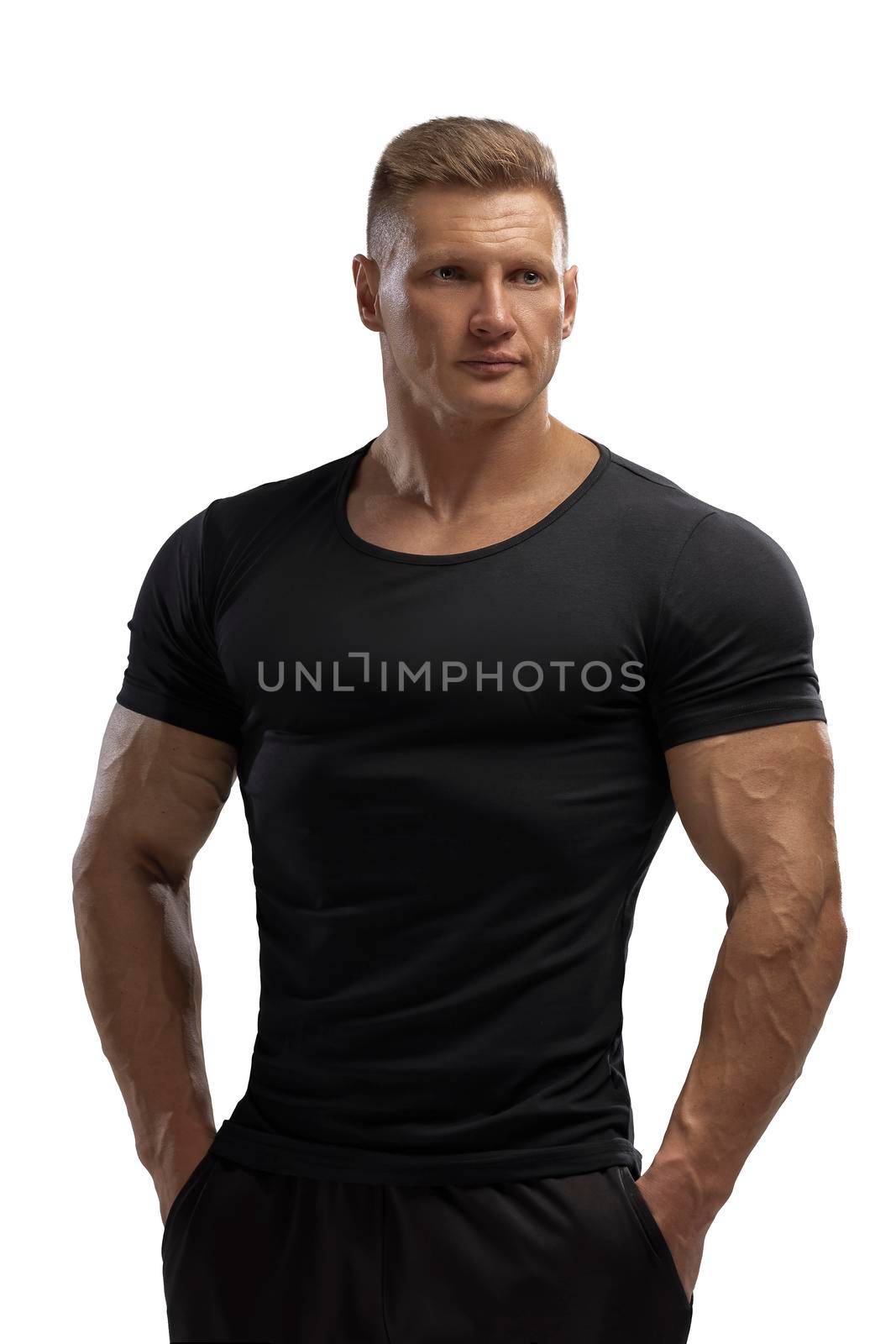 Portrait of an attractive athlete in a black t-shirt on a white cyclorama in the studio. Sports lifestyle.