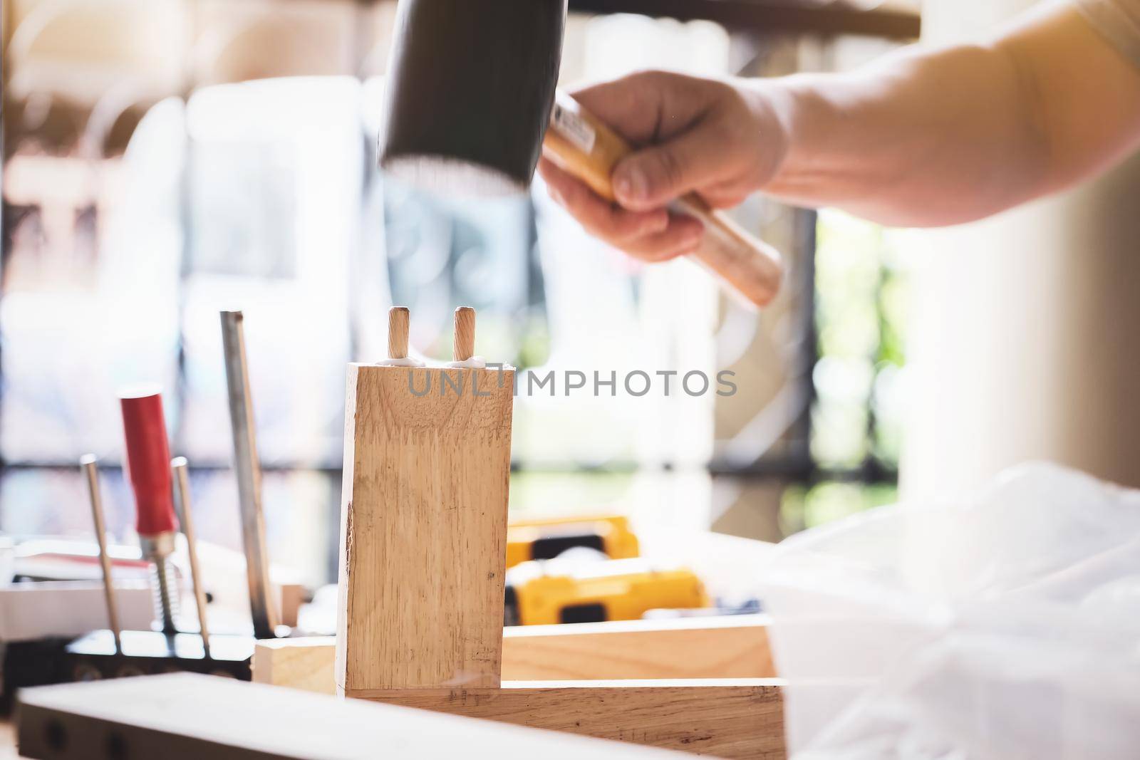 Focus on the woodwork, Entrepreneur Woodwork holding hammer to assemble the wood pieces as the customer ordered