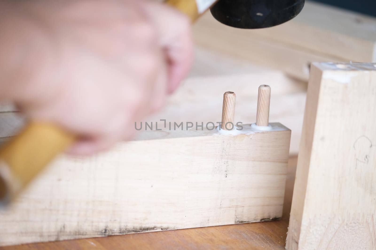 Focus on the woodwork, Entrepreneur Woodwork holding hammer to assemble the wood pieces as the customer ordered