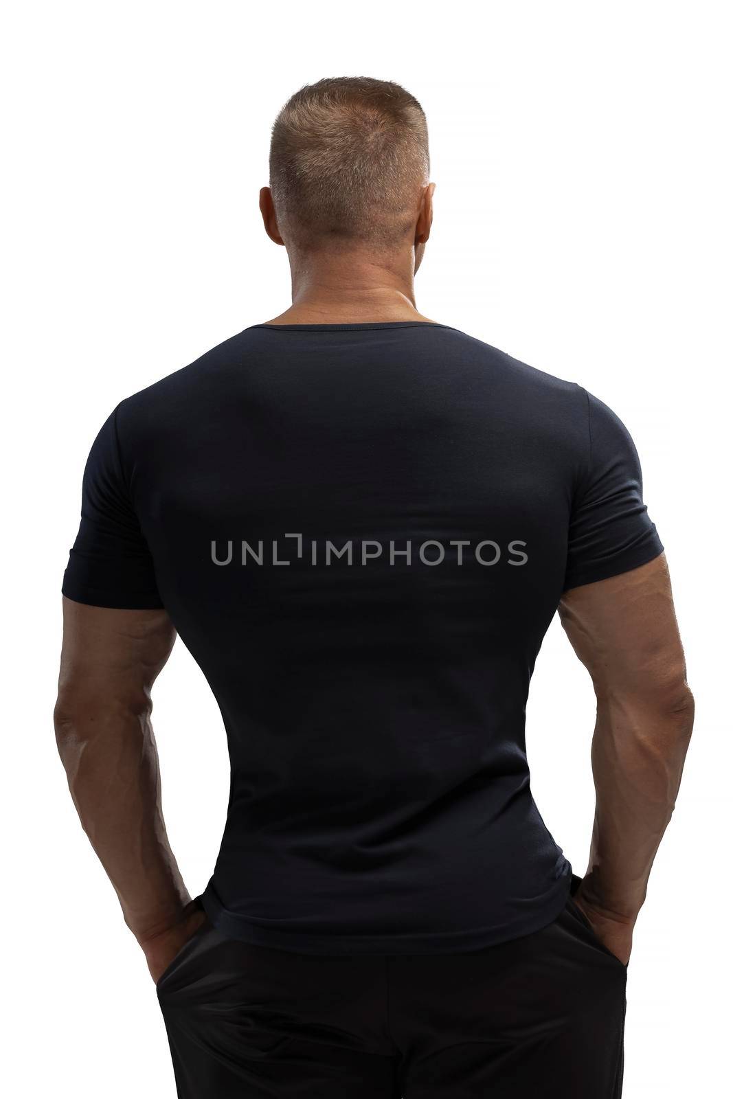 Handsome athletic man posing in T-shirt on a white background by but_photo