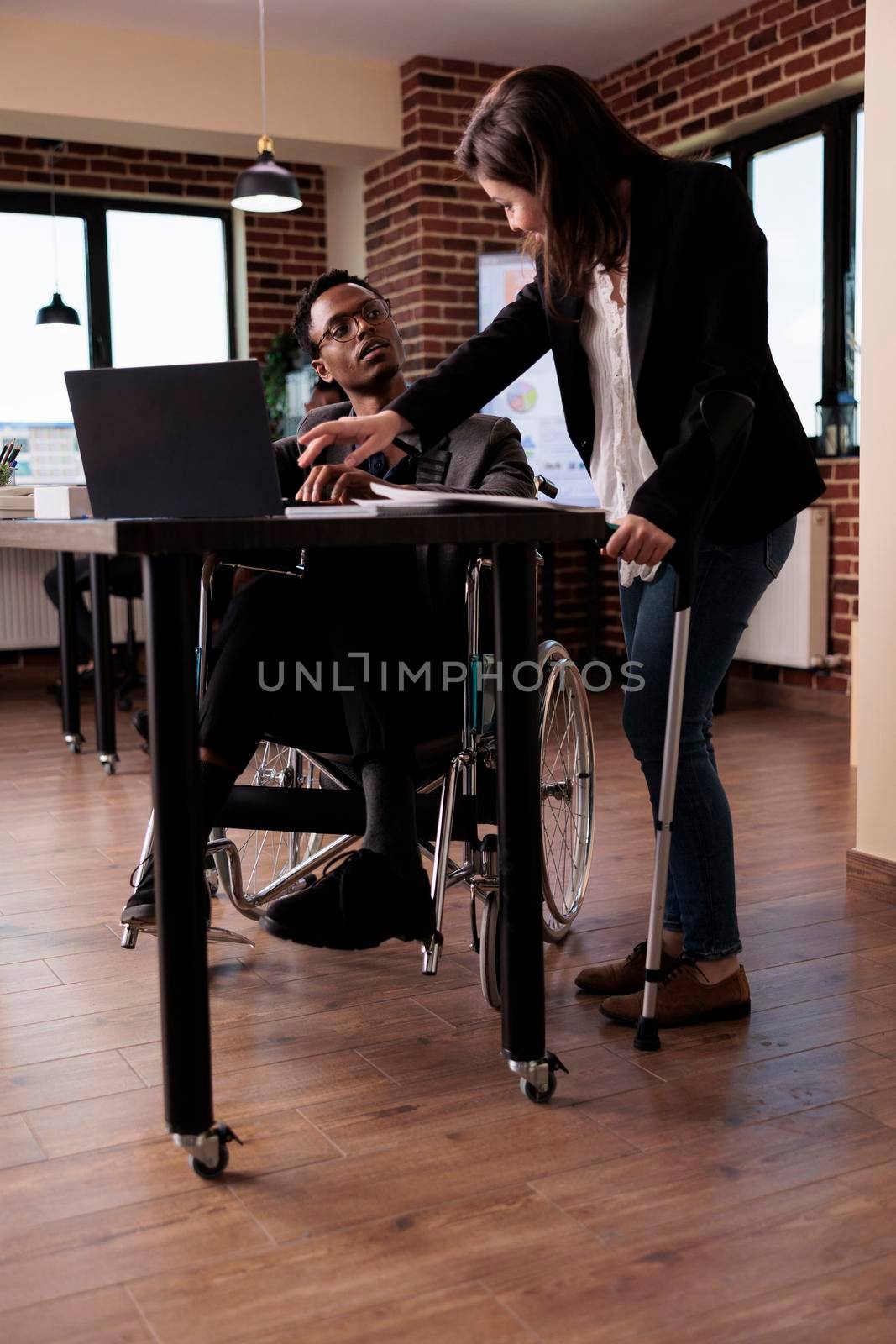 Multiethnic team of businesspeople with chronic impairment by DCStudio