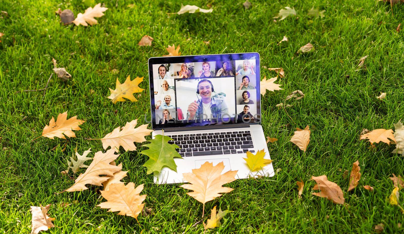 laptop with video in leaves autumn