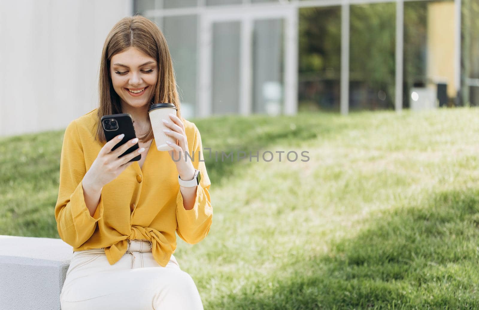 Portrait of business woman reading messages on cellphone. Happy businesswoman using mobile phone at remote workplace. Smiling woman browsing internet on smartphone near office.
