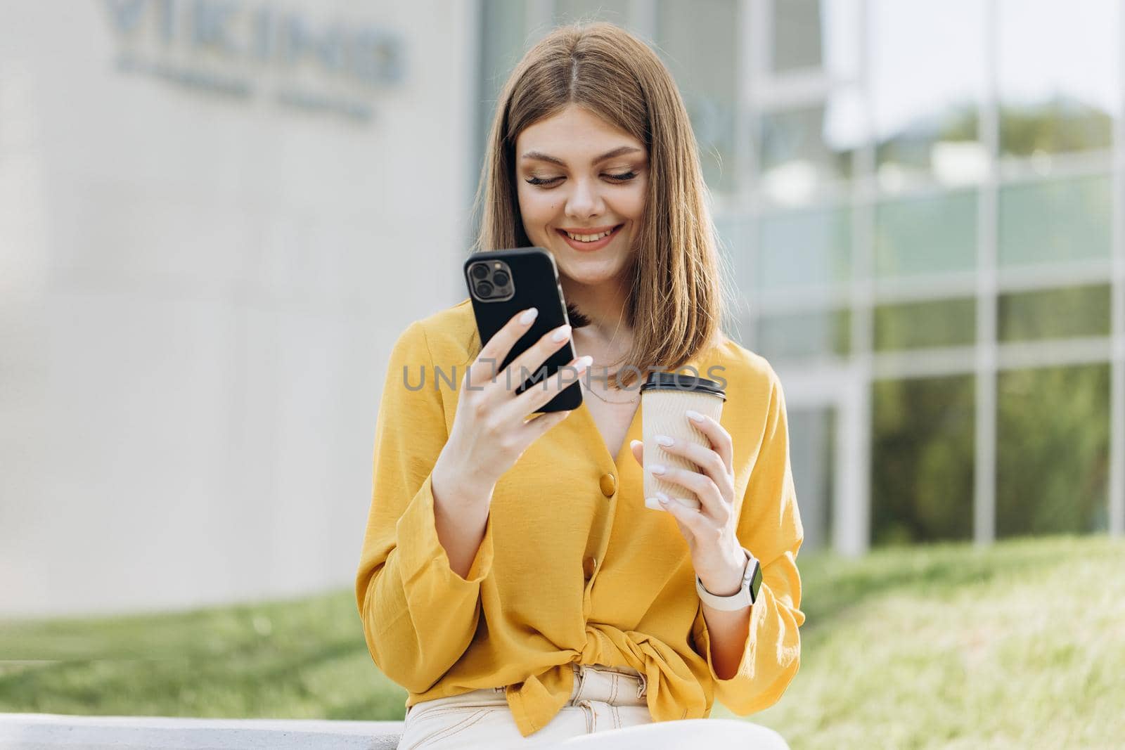 Appealing young elegant caucasian woman using social media application on smartphone text messages receive news smiling outdoor. People portraits and technology concept.
