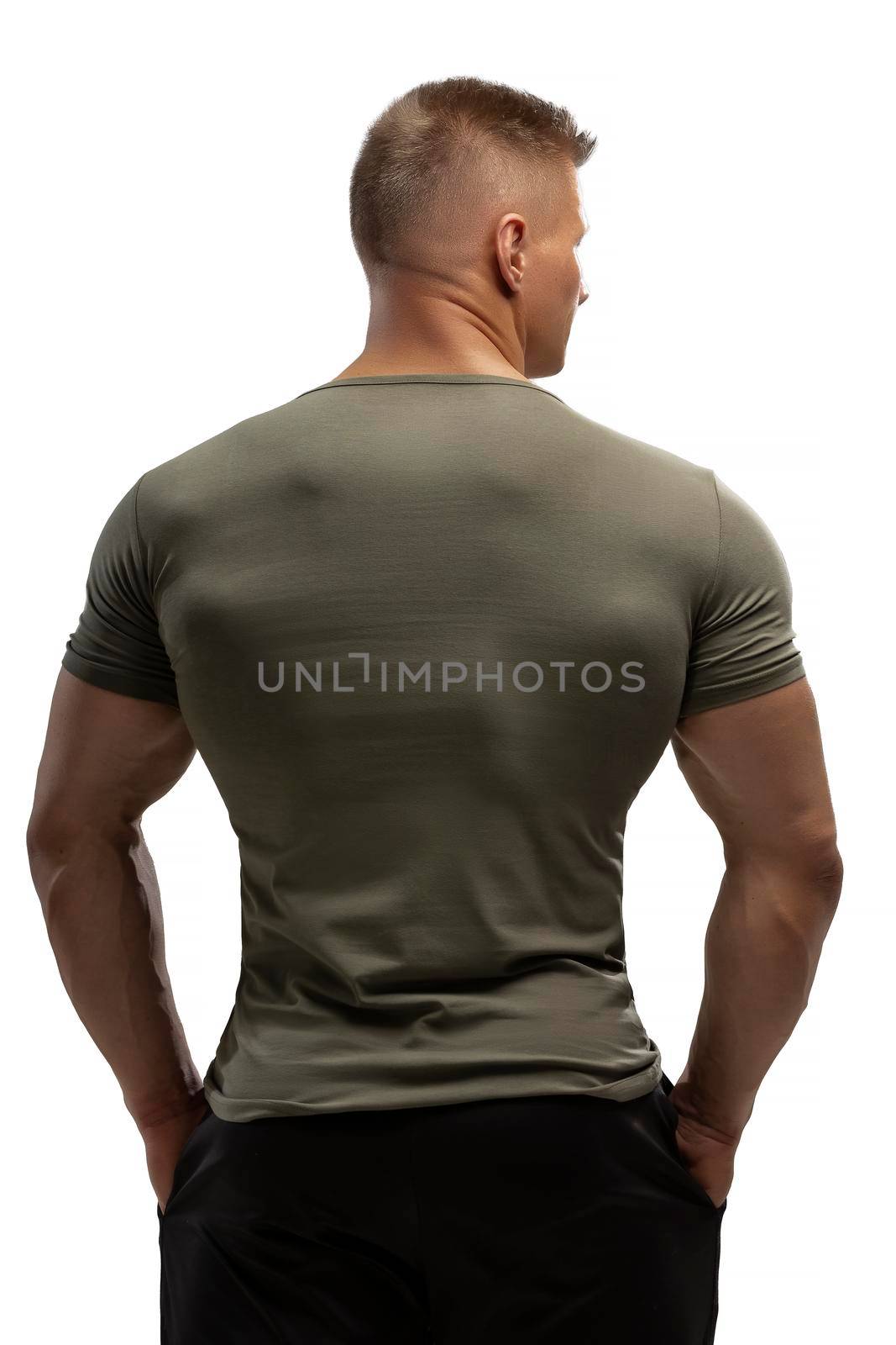 Handsome athletic man posing in T-shirt on a white background by but_photo