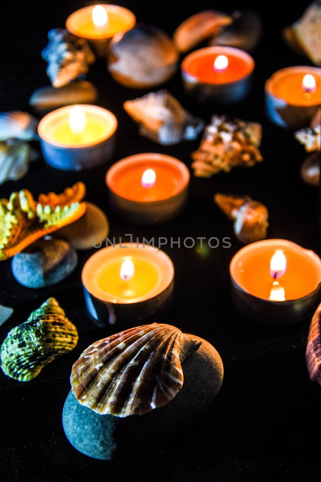 Candles, stones and shell in spa, light at night by anna_stasiia