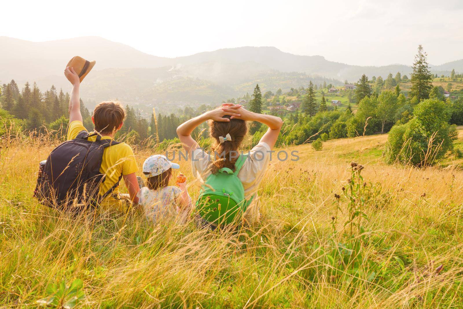 Happy family mountain vacation time together travel lifestyle nature. Tourists hiking family lifestyle vacation holiday summer travel local trekking mountains. Green travel family nature. Waving hello by synel