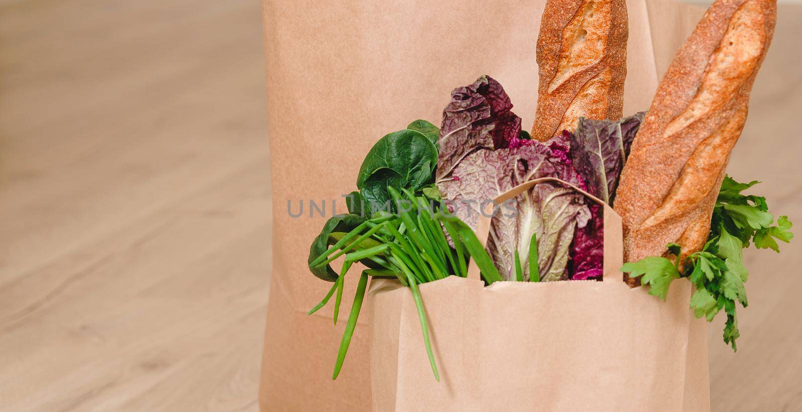 Paper bag with vegetables and some bread with copy space