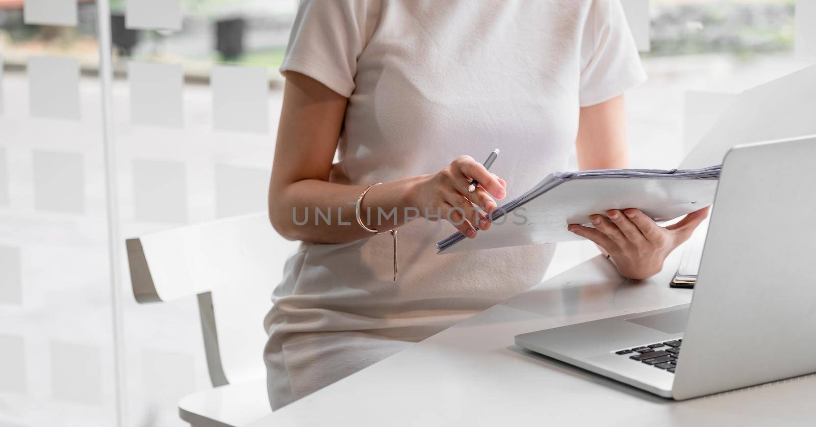 Audit working, Businesswoman work with paper document on clipping board in office.