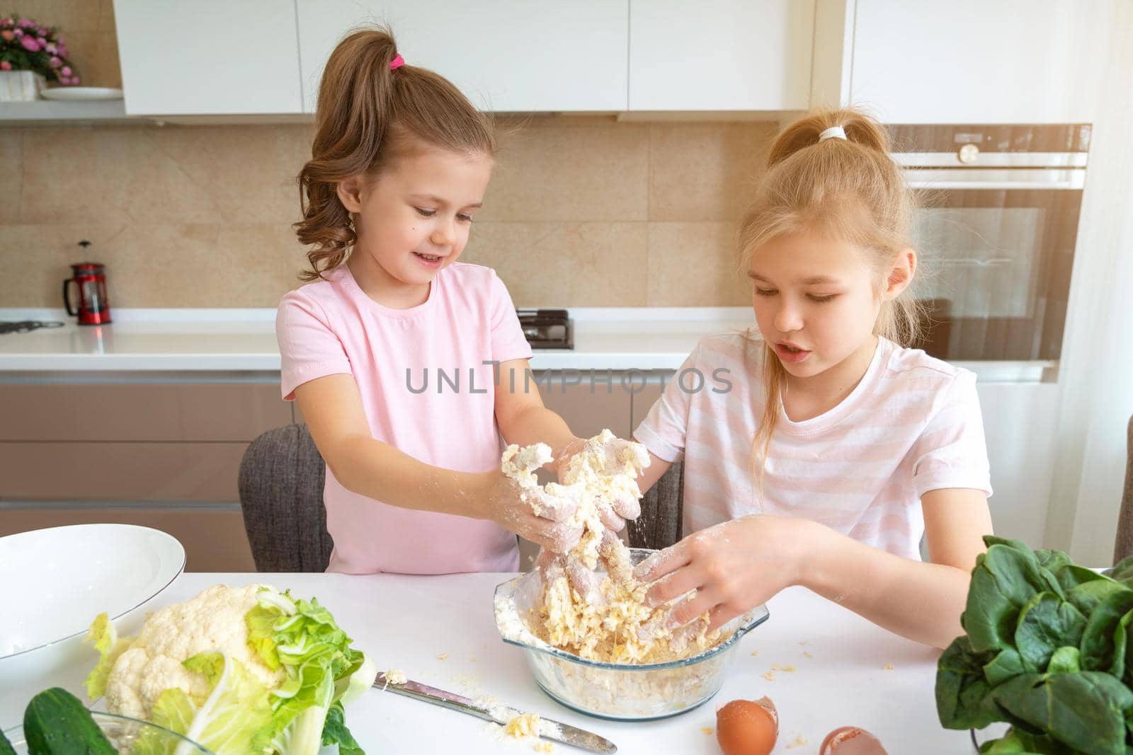 happy family funny kids are preparing the dough, bake cookies in the kitchen